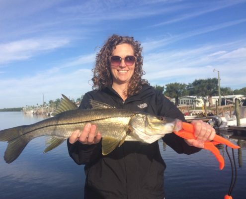 This happy young lady shows off a sweet snook.