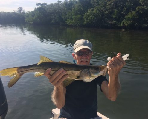 This young fella is showing off a backwater Snook!